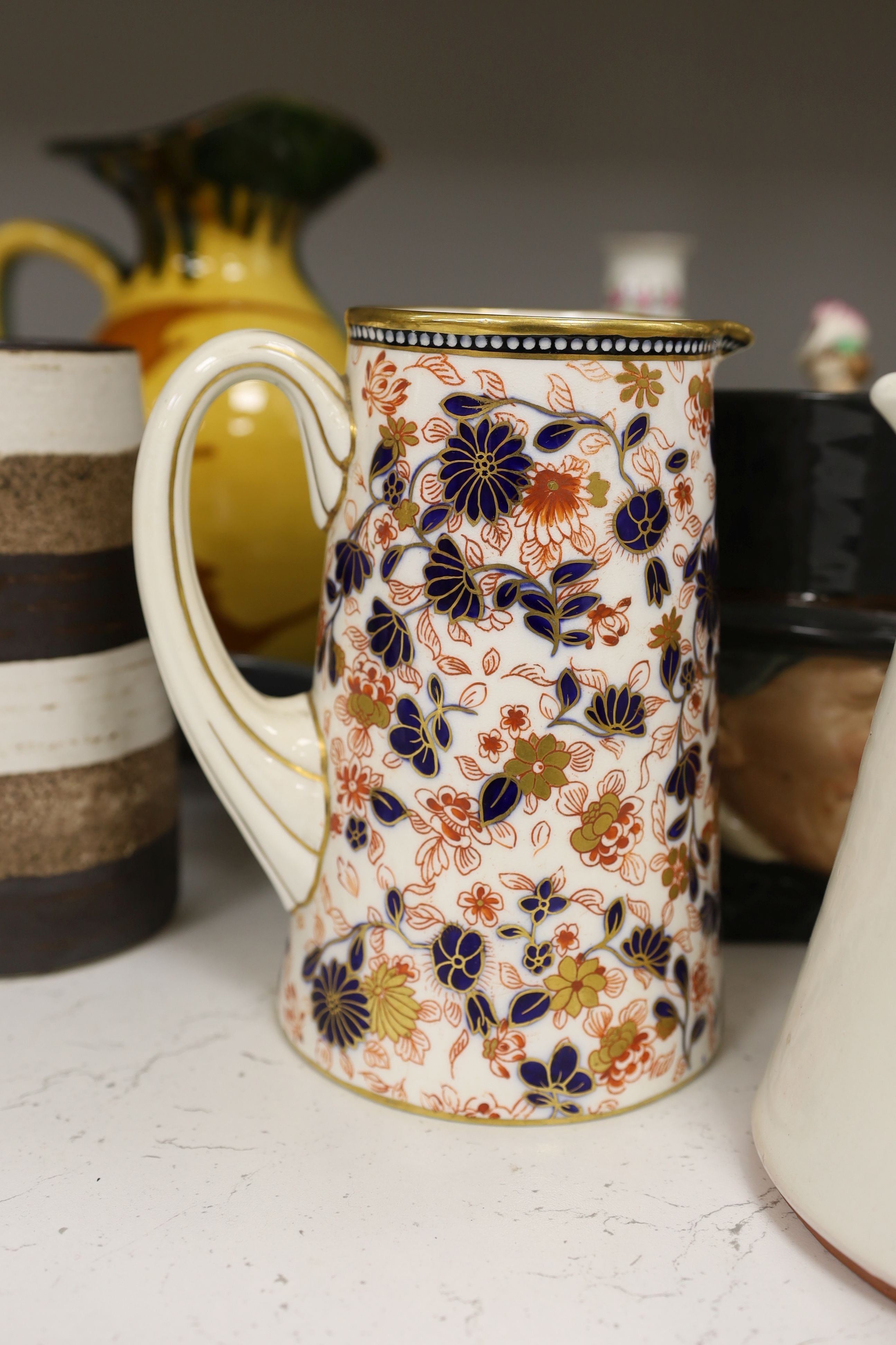 A pair of Dresden candlesticks, various art pottery jugs and a dish and other ceramics